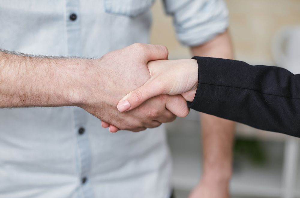 Homeowner shaking hands on a cash offer